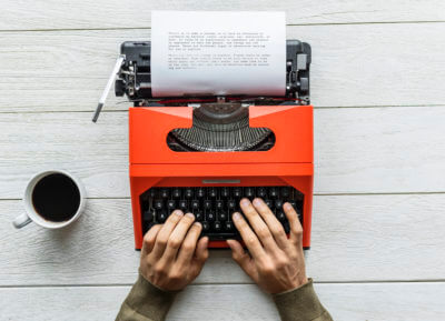View of the author typing on a retro typewriter